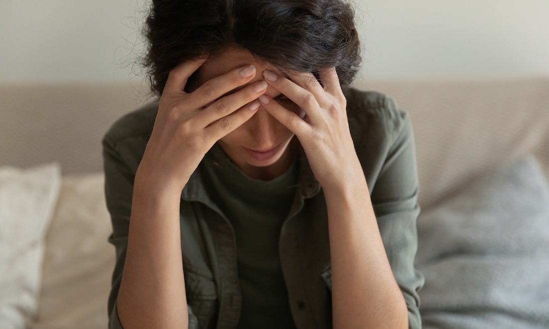 woman with anxiety, head in hands