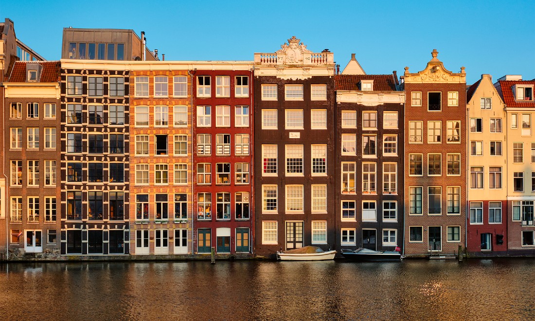 Canal houses boats Amsterdam sunset