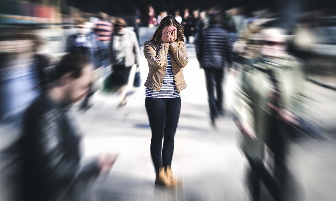 woman having panic attack in crowded street