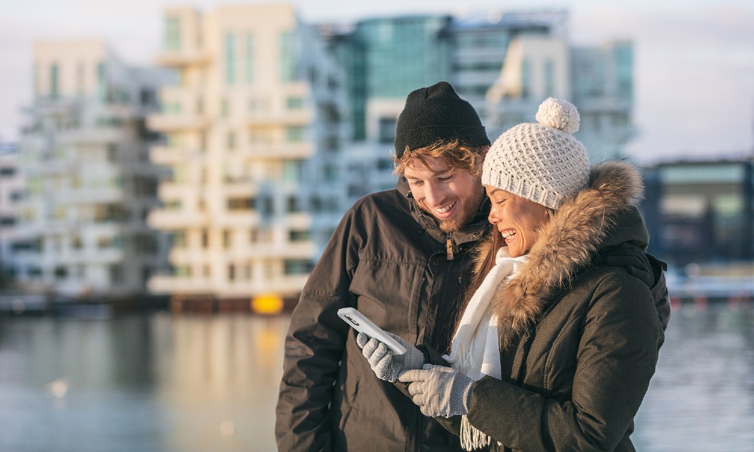 couple on walk, looking at their phone for directions