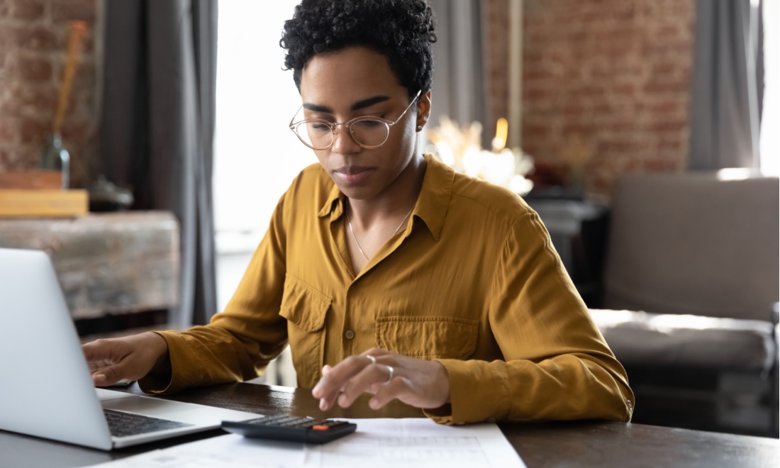 woman doing taxes behind laptop - bdo: consequences of the proposed 30% ruling changes 