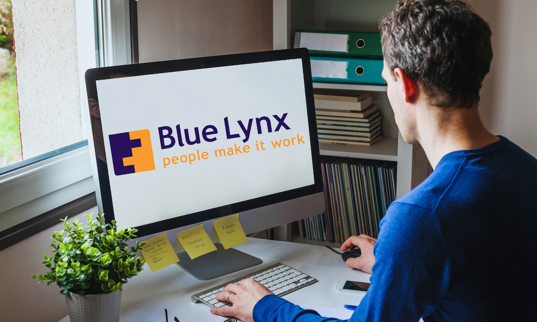 Man at computer with Blue Lynx logo