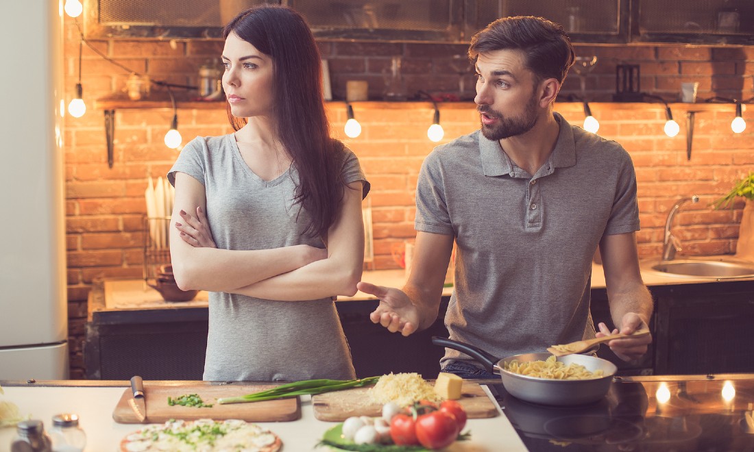 woman and man arguing in kitchen - how to enforce boundaries