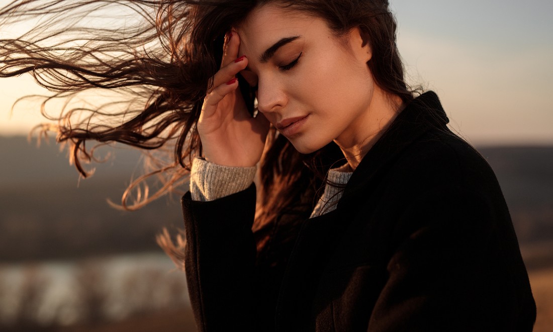 woman on beach, looking sad