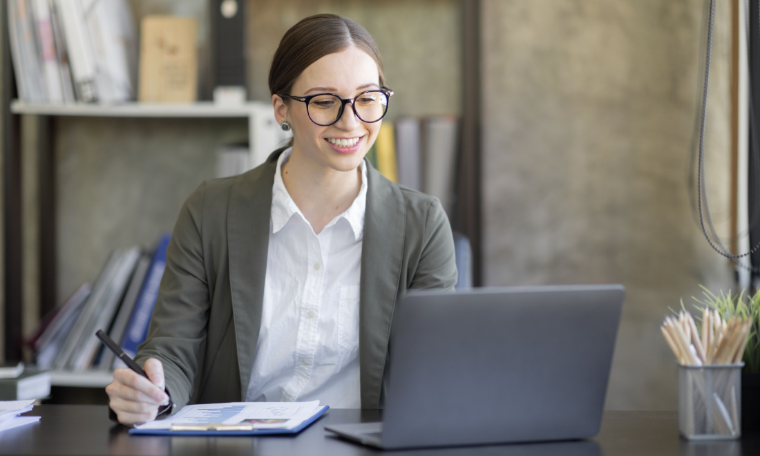 business woman smiling at computer