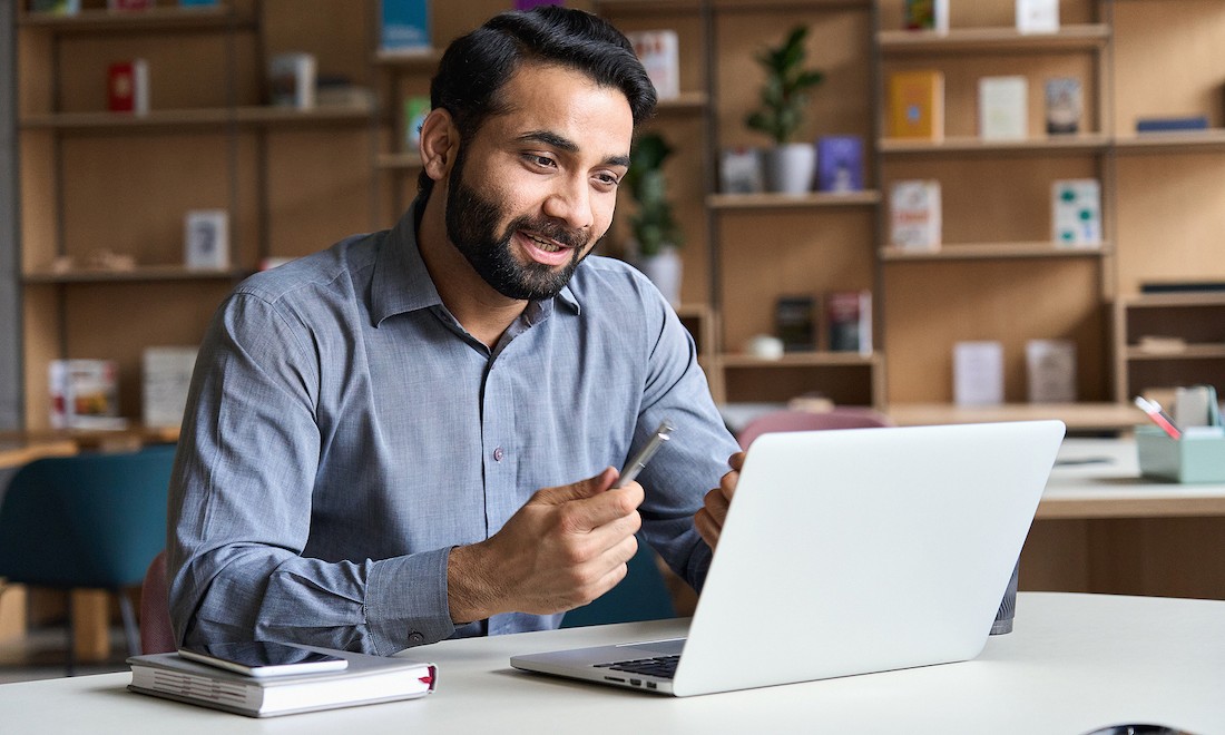 Businessman checking his payslip on laptop