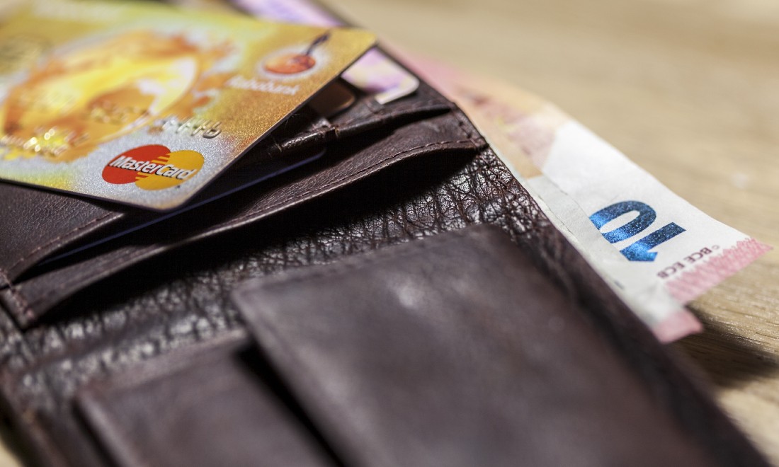 euro notes and Dutch debit card in a brown leather wallet