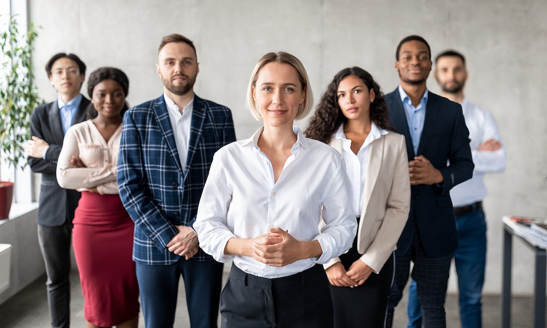 Businesswoman standing in front of team