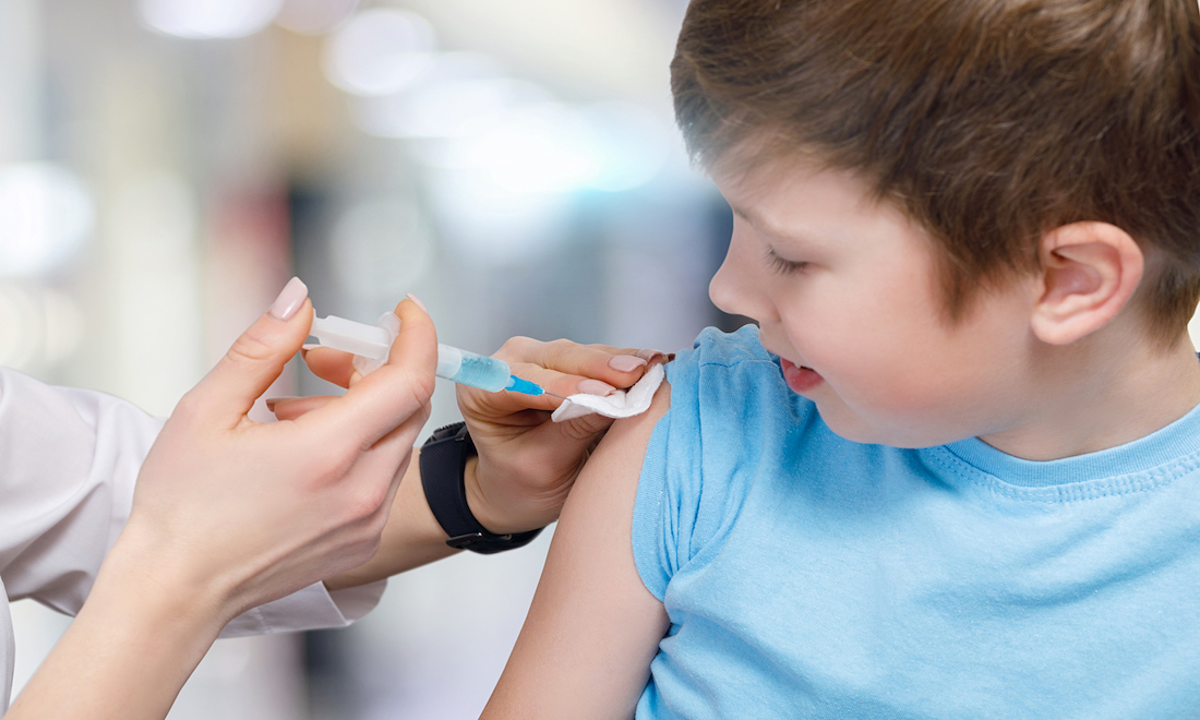 Child being vaccinated at school