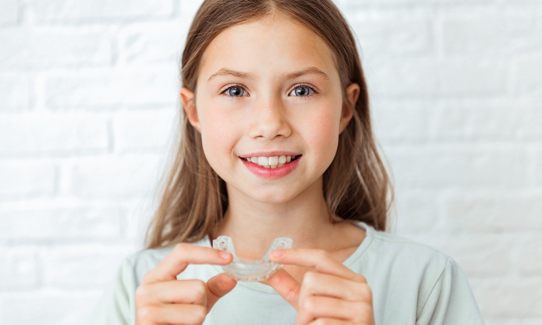 Girl using clear aligner