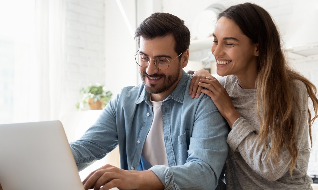 Couple smiling, reading online