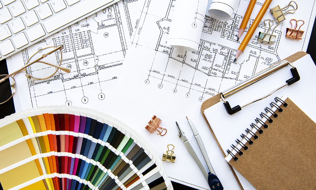 desk of architect with colour charts, plans etc.