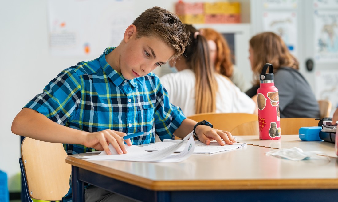 young boy studying in classroom