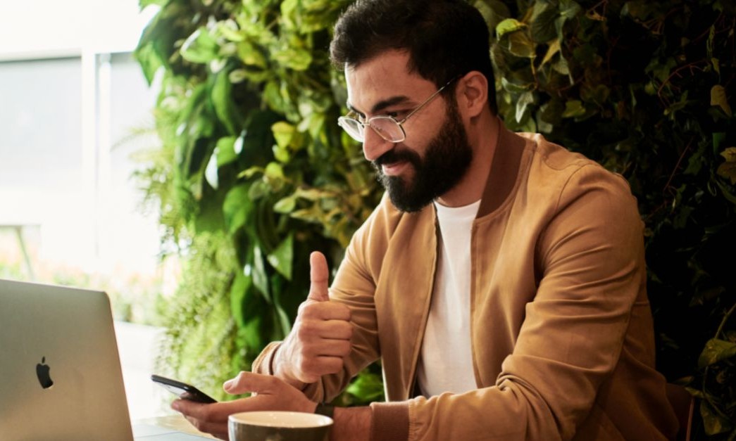 guy learning on laptop giving thumbs up