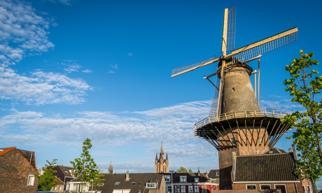 dutch windmill under blue sky delft