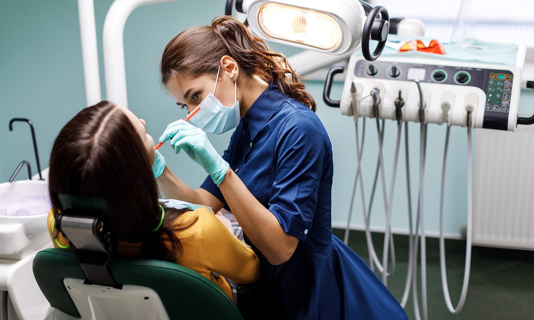 Dentist performing checkup at surgery