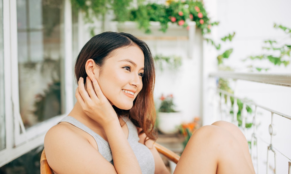 woman on balcony looking happy