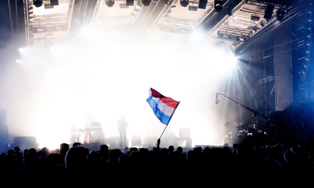 DirectDutch waving Dutch flag at concert