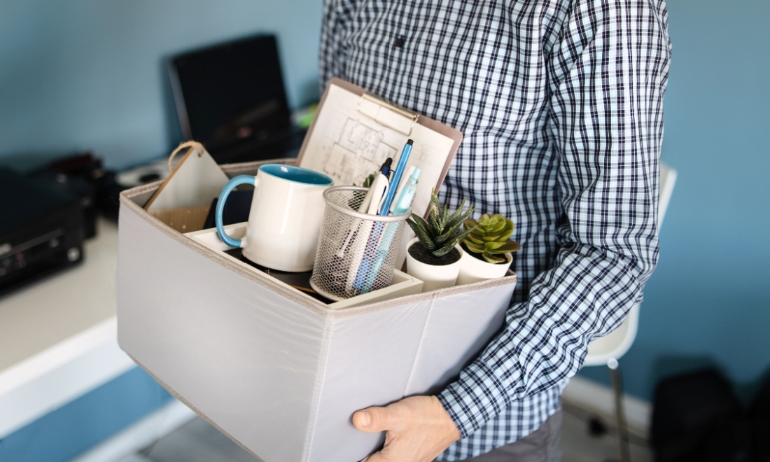 Dismissal Specialist man holding box of items