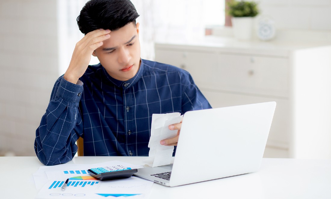 man doing his taxes looking worried