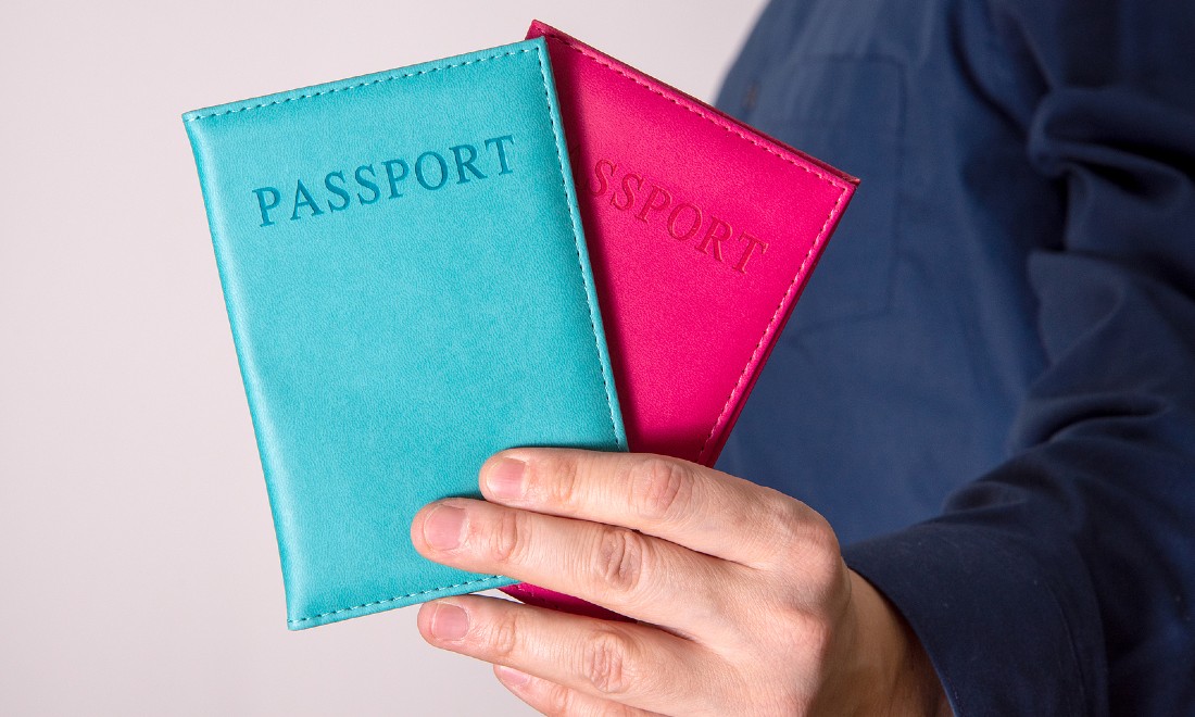 person holding two passports - Dual citizenship: Regaining your original nationality after you renounced it as part of your naturalisation procedure in the Netherlands