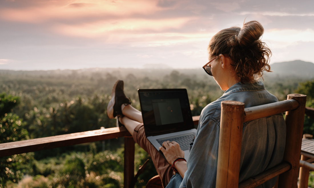 Dutch Employer of Record woman on laptop near scenery