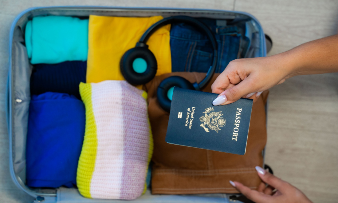 ExpatLaw woman holding US passport with luggage