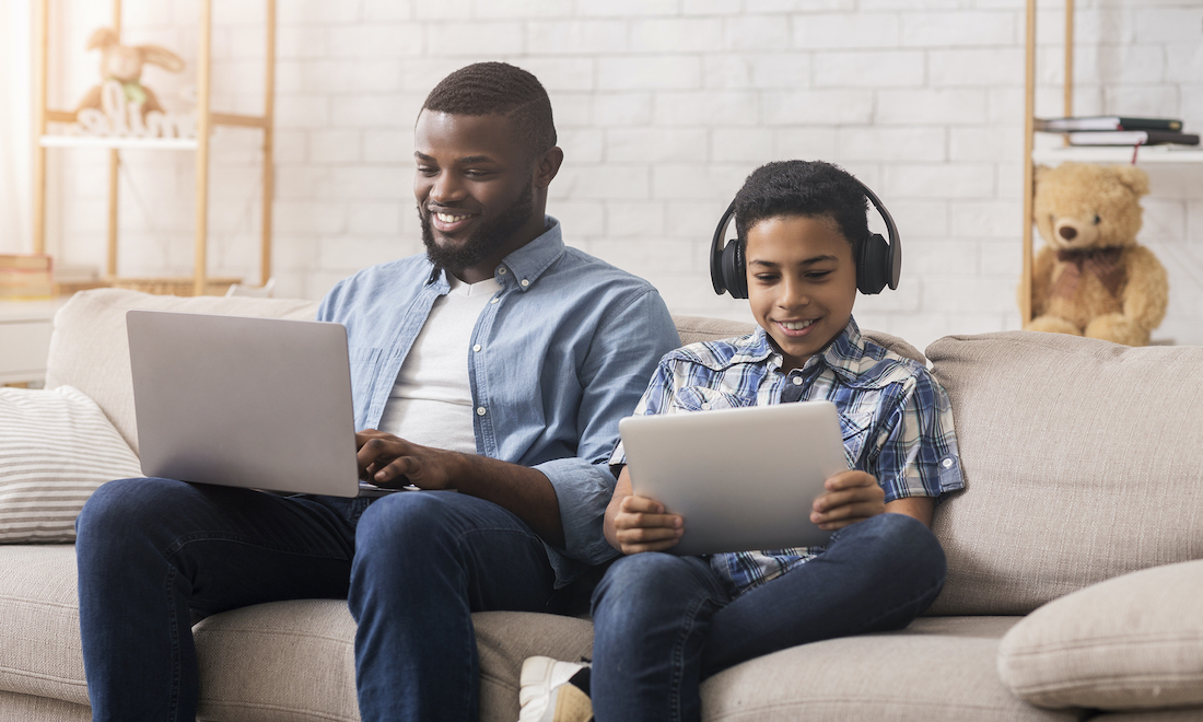 Father and son using devices