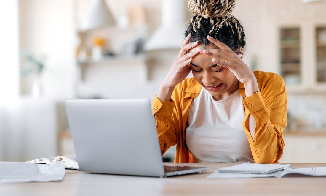 Frustrated woman at laptop