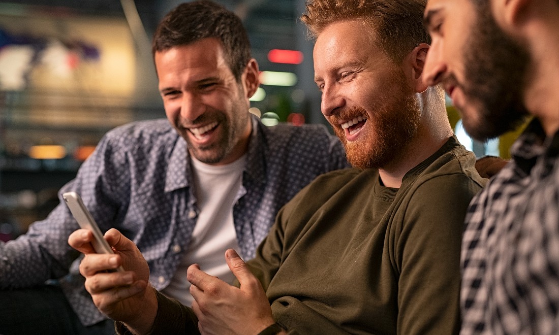 Group men friends laughing phone