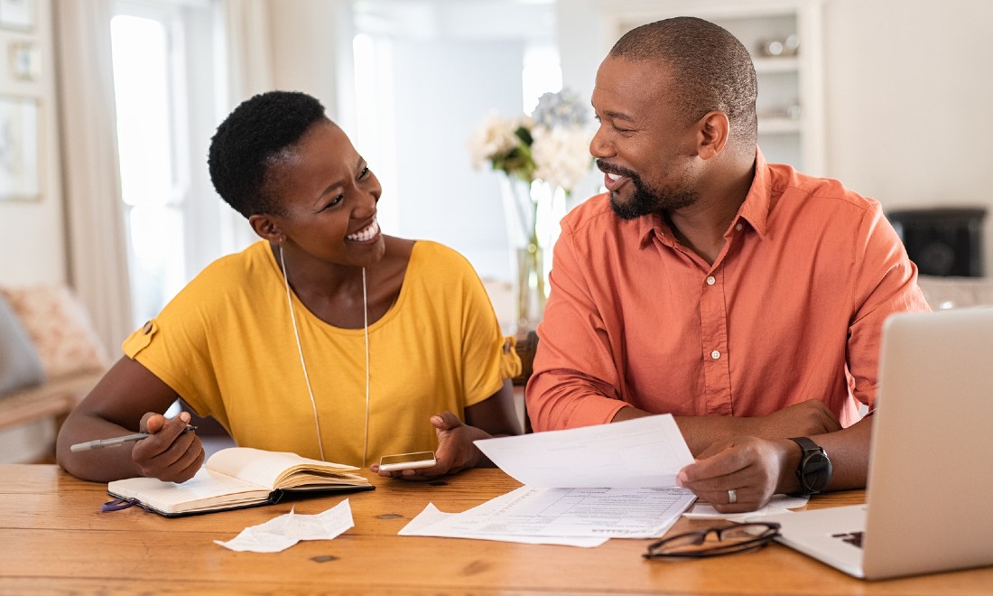 Happy couple reviewing bills