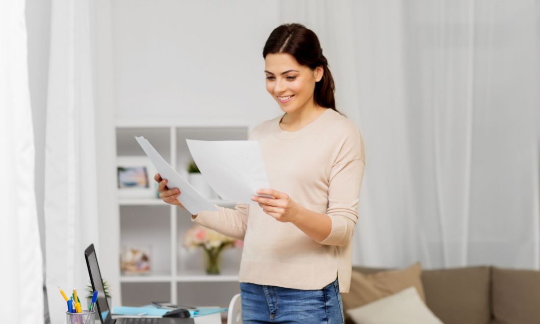 PSM Consulting happy woman looking at paper