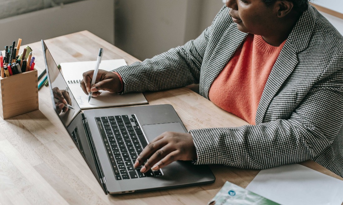 woman behind laptop, working