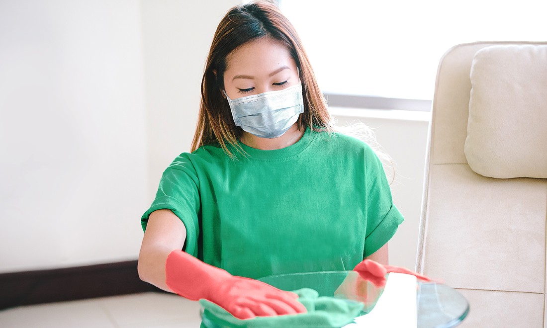 woman from Helpling cleaning wearing face mask