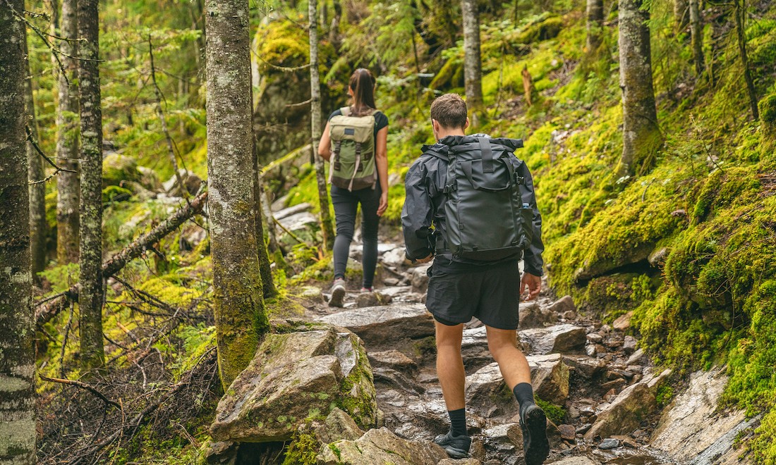 Man and woman hiking in forest