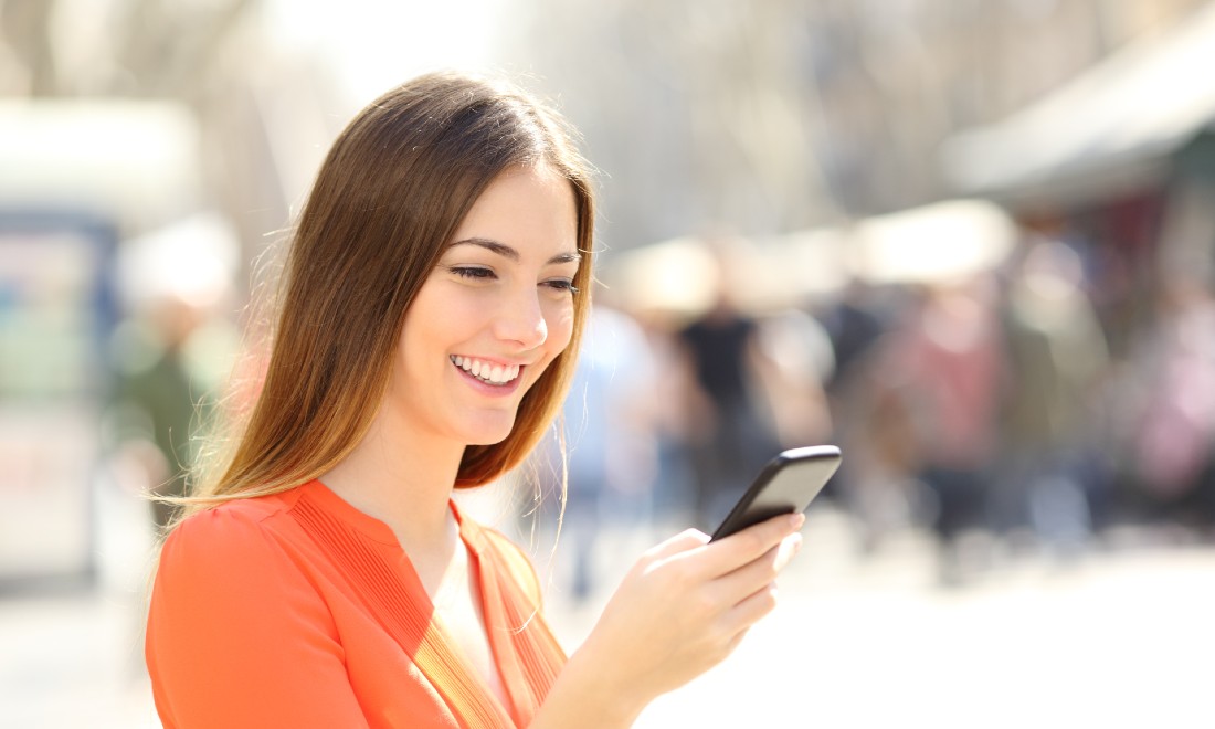 ING woman smiling at smartphone