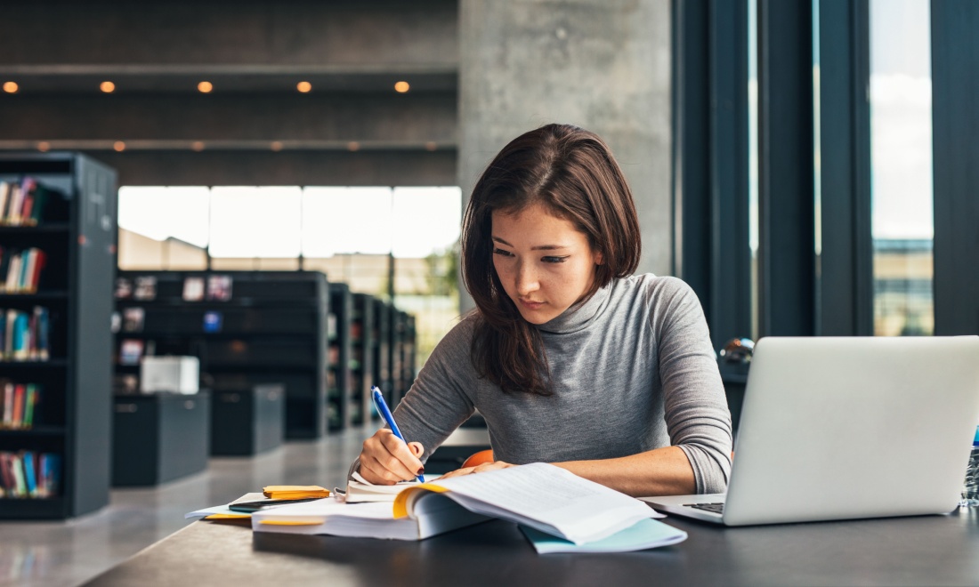 IronHack female student taking notes