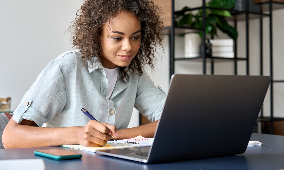 woman following language class online via laptop