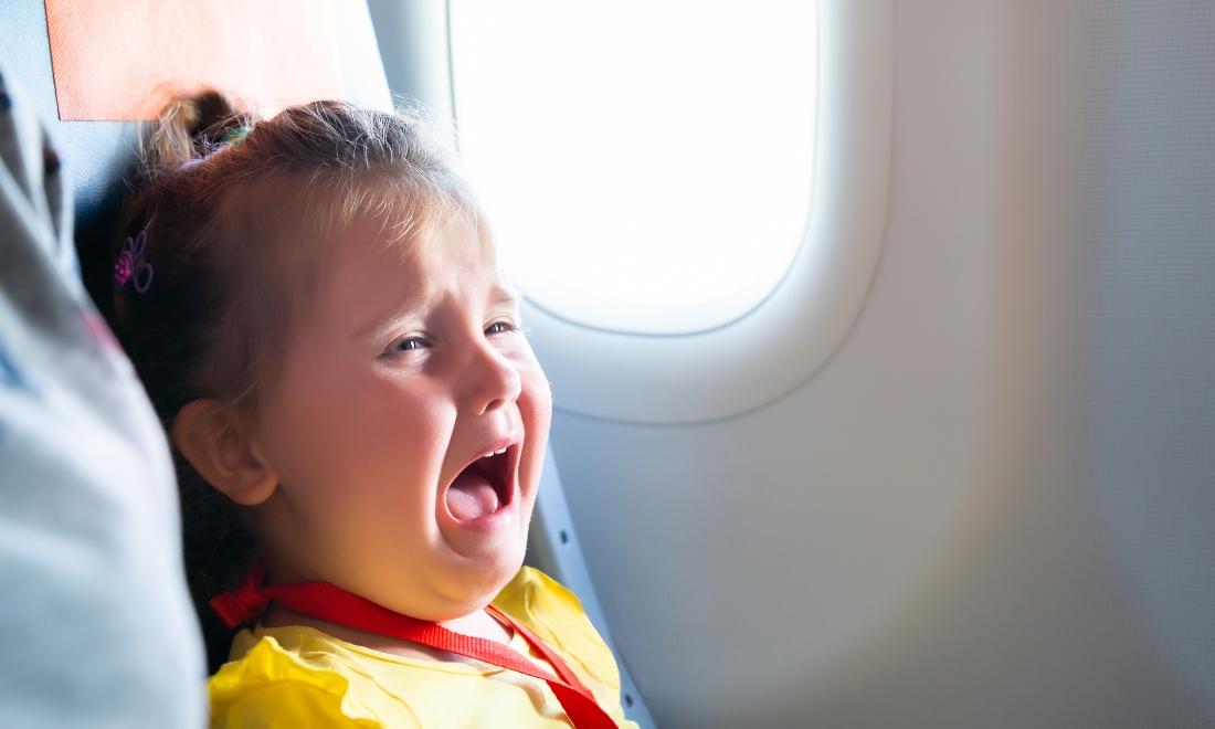 Young child crying on a plane