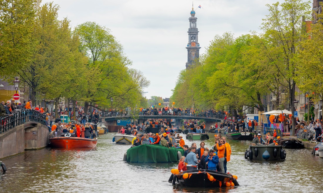 Boats on the canals in Amsterdam on King's Day (Koningsdag)