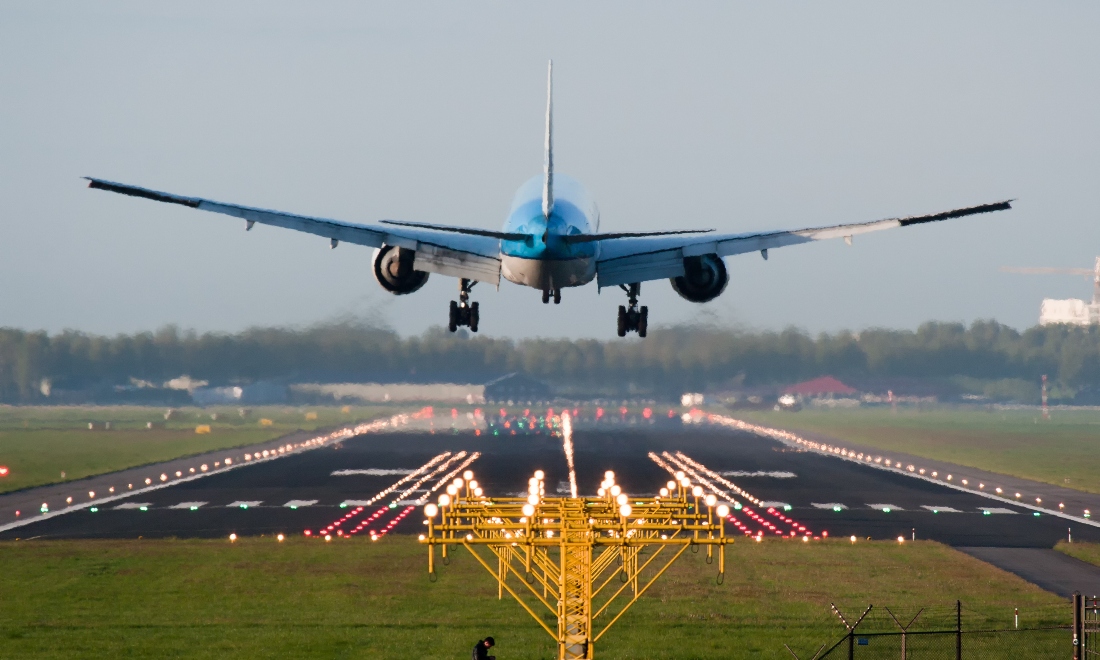 KLM plane landing on runway at Schiphol Amsterdam Airport