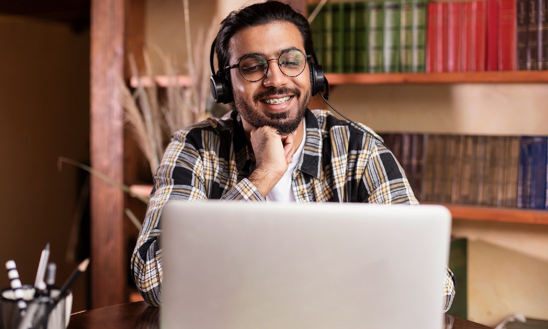 man laughing at computer