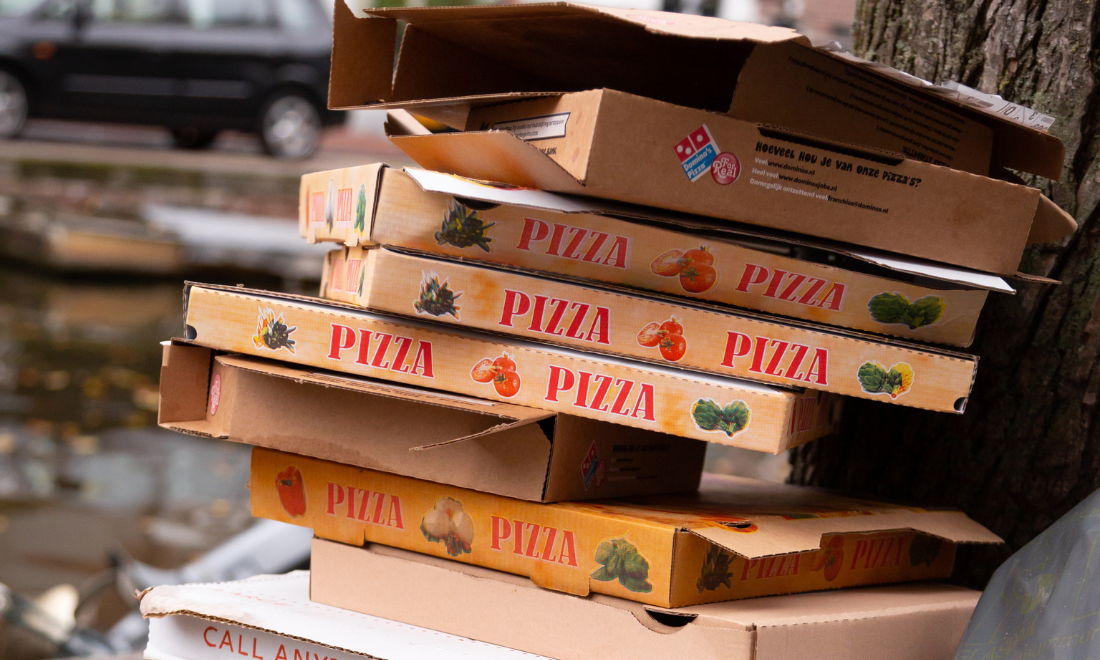 Pile of pizza boxes littering park