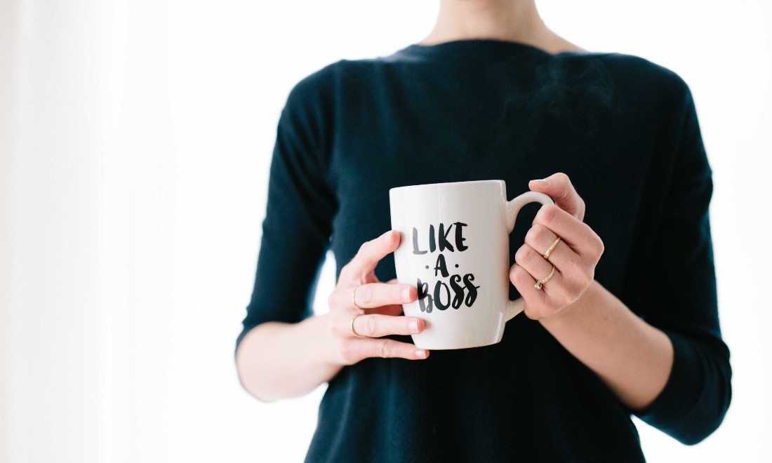 woman holding mug that says like a boss