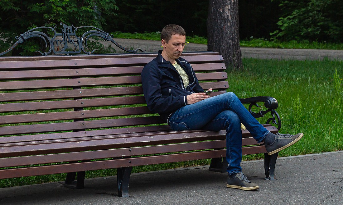 Man sitting on a bench on his own