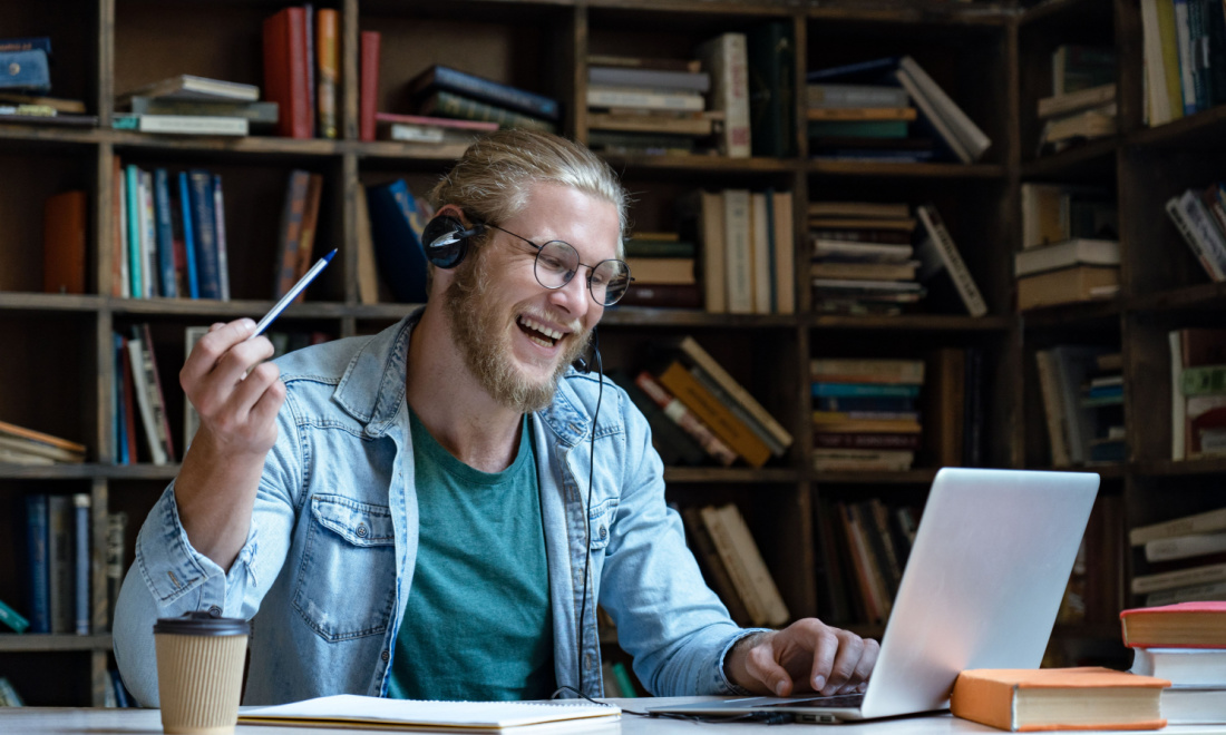 man laughing using laptop