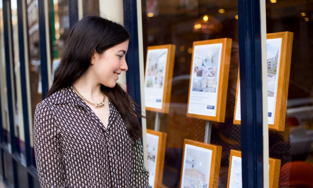 woman looking at houses realtor