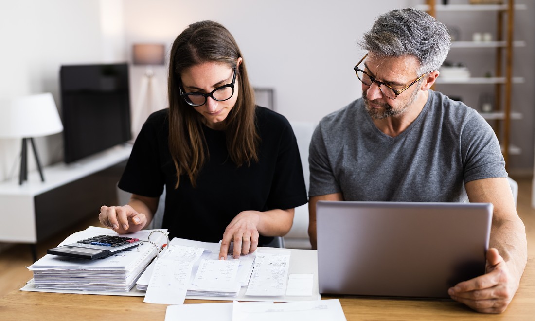 couple doing taxes laptop