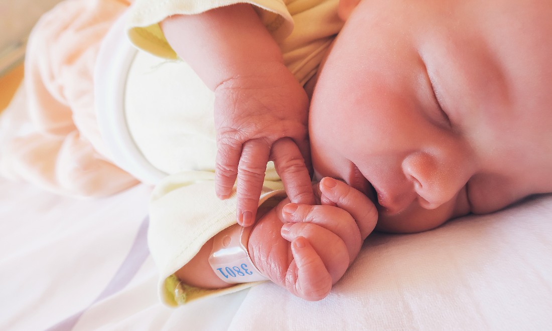 new born baby with name tag