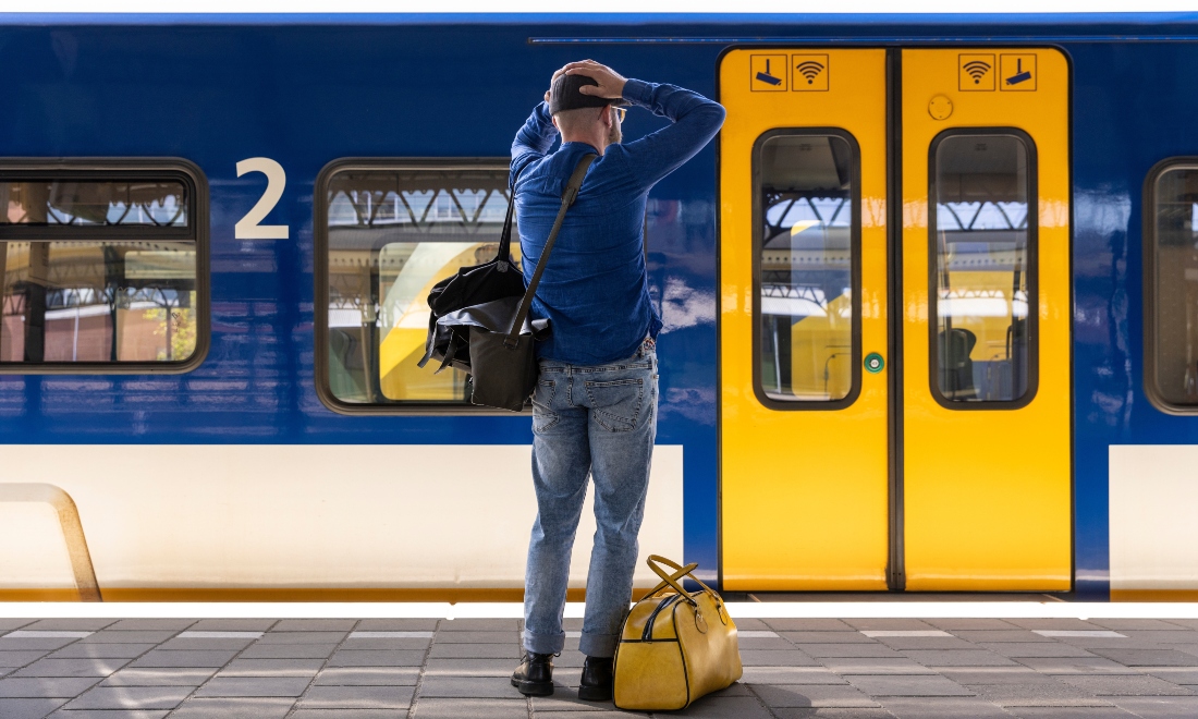 Man waiting for NS train at Dutch train station